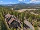 A captivating aerial view of this mountain home surrounded by lush greenery and a scenic driveway at 6530 Ridgeview Dr, Morrison, CO 80465