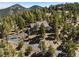 Secluded mountain home nestled among tall trees, accessible via a winding driveway, offering privacy at 6530 Ridgeview Dr, Morrison, CO 80465
