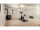 Basement workout area with a wood-burning stove and bright windows at 6530 Ridgeview Dr, Morrison, CO 80465