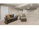 Cozy basement with plush carpet, neutral walls, and comfortable seating at 6530 Ridgeview Dr, Morrison, CO 80465
