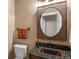 Charming powder room with granite countertop, copper sink, decorative mirror, and rustic accents, for a unique and inviting space at 6530 Ridgeview Dr, Morrison, CO 80465