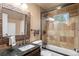 Tastefully designed bathroom with a large mirror, tiled shower, and vanity with granite countertop at 6530 Ridgeview Dr, Morrison, CO 80465