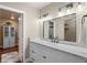 Renovated bathroom featuring double sinks with marble countertops, a large mirror, and modern lighting at 6530 Ridgeview Dr, Morrison, CO 80465