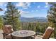 Enjoy breathtaking mountain views from this deck with comfortable seating around a cozy fire pit at 6530 Ridgeview Dr, Morrison, CO 80465