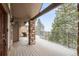 Spacious deck with stone pillar and railing offering picturesque views of the surrounding landscape at 6530 Ridgeview Dr, Morrison, CO 80465