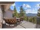 Spacious deck with outdoor seating offers stunning views of the surrounding landscape and mountains at 6530 Ridgeview Dr, Morrison, CO 80465