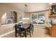 Dining area with hardwood floors, pendant lighting, large windows with winter views, and easy access to the cozy living room at 6530 Ridgeview Dr, Morrison, CO 80465