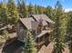 Beautiful mountain home featuring an expansive deck, stone accents, and lush natural surroundings at 6530 Ridgeview Dr, Morrison, CO 80465