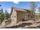 A spacious home features a walkout basement, a large wooden deck, and a wooded surrounding at 6530 Ridgeview Dr, Morrison, CO 80465