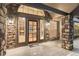Elegant front entrance with stone detailing and a glimpse into the cozy living room with fireplace at 6530 Ridgeview Dr, Morrison, CO 80465