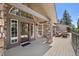 Charming front entrance with stone accents and an inviting outdoor seating area on a spacious deck at 6530 Ridgeview Dr, Morrison, CO 80465