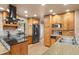 Well-lit kitchen with wood cabinets, granite countertops, and modern appliances at 6530 Ridgeview Dr, Morrison, CO 80465