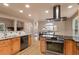 Spacious kitchen featuring wood cabinets, granite counters, modern appliances, and an eat-in dining area with natural light at 6530 Ridgeview Dr, Morrison, CO 80465
