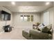 Comfortable living room with large windows, a sofa, and TV, ideal for relaxation and entertainment at 6530 Ridgeview Dr, Morrison, CO 80465