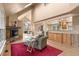 Inviting living room with vaulted ceilings, stone fireplace, hardwood floors, and seamless flow to the kitchen at 6530 Ridgeview Dr, Morrison, CO 80465