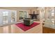Cozy living room features hardwood floors, a stone fireplace, and french doors leading to the deck at 6530 Ridgeview Dr, Morrison, CO 80465