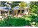 Beautiful backyard featuring a wooden deck, patio, and lush green lawn at 6684 E Bates Ave, Denver, CO 80224