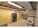 Unfinished basement with a safe, shelving unit, and laundry area at 6684 E Bates Ave, Denver, CO 80224
