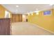 Finished basement providing extra living space with built-in shelving and ample lighting at 6684 E Bates Ave, Denver, CO 80224