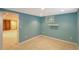 Cozy bedroom with blue walls, carpet, and a bright window at 6684 E Bates Ave, Denver, CO 80224