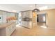 Well-equipped kitchen featuring white cabinetry, an island, and a view of the entryway at 6684 E Bates Ave, Denver, CO 80224