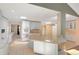 Modern kitchen with white cabinets, a central island, stainless steel appliances, and plenty of natural light at 6684 E Bates Ave, Denver, CO 80224