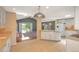 Bright and open kitchen with white cabinetry, a large island, and seamless flow into the living area at 6684 E Bates Ave, Denver, CO 80224