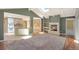 Bright living room with a cozy fireplace, hardwood floors, and an open layout connecting to the kitchen at 6684 E Bates Ave, Denver, CO 80224