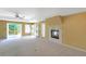 Cozy bedroom with plush carpet, access to the outdoors, and a fireplace at 6684 E Bates Ave, Denver, CO 80224