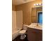 Bathroom with a tub/shower combo, white tile surround, single sink vanity, and neutral walls at 20787 E 39Th Ave, Denver, CO 80249