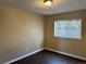 This vacant bedroom boasts laminate wood flooring, neutral walls, and a window for natural light at 20787 E 39Th Ave, Denver, CO 80249