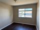 Vacant bedroom offering laminate wood flooring, neutral walls, and a window providing natural light and neighborhood views at 20787 E 39Th Ave, Denver, CO 80249