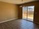 Vacant dining room features tile floors, a modern chandelier, and a sliding glass door leading to the backyard at 20787 E 39Th Ave, Denver, CO 80249