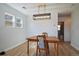 Stylish dining room featuring modern lighting, wood table and floors, and fresh, white paint at 1947 Jay St, Lakewood, CO 80214