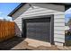 Exterior shot of garage with dark trim and matching paneled garage door, providing secure parking or storage at 1947 Jay St, Lakewood, CO 80214