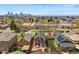 An aerial view shows a charming home with a concrete patio and lush lawn in a vibrant neighborhood at 2716 N Columbine St, Denver, CO 80205