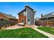 This backyard has a concrete patio with an outdoor couch and manicured lawn at 2716 N Columbine St, Denver, CO 80205