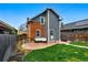 This backyard features a concrete patio with lounge seating and a well-maintained lawn at 2716 N Columbine St, Denver, CO 80205