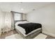 Neutral bedroom with a large window and warm, soft lighting at 2716 N Columbine St, Denver, CO 80205