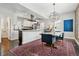 Beautiful dining room features modern lighting fixture, eye-catching rug and view into the kitchen at 2716 N Columbine St, Denver, CO 80205