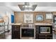 Gourmet kitchen features exposed brick wall, stainless appliances, and large center island at 2716 N Columbine St, Denver, CO 80205