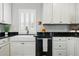 Bright kitchen featuring a farmhouse sink, stainless steel appliances, and white cabinetry at 2716 N Columbine St, Denver, CO 80205