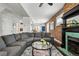 Open-concept living room with exposed brick, comfortable sofa, and ample natural light at 2716 N Columbine St, Denver, CO 80205