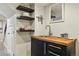 Wet bar with stylish shelves and sink in finished basement at 2716 N Columbine St, Denver, CO 80205