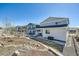 Wide shot of the backyard featuring grass, a patio and gravel area, and a white fence at 4327 Wilson Peak Dr, Castle Rock, CO 80104