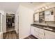 Bathroom featuring granite counters, soft-close white cabinetry, and a walk-in closet nearby at 4327 Wilson Peak Dr, Castle Rock, CO 80104
