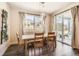 Bright dining room featuring a wooden table set, modern lighting and sliding glass doors to outdoor living space at 4327 Wilson Peak Dr, Castle Rock, CO 80104