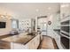 Modern kitchen with white cabinets, granite countertops, stainless steel appliances, and open to living area at 4327 Wilson Peak Dr, Castle Rock, CO 80104