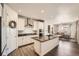 Modern kitchen with white cabinets, granite countertops, stainless steel appliances, and kitchen island at 4327 Wilson Peak Dr, Castle Rock, CO 80104