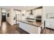 Modern kitchen with white cabinets, granite countertops, stainless steel appliances, and kitchen island at 4327 Wilson Peak Dr, Castle Rock, CO 80104